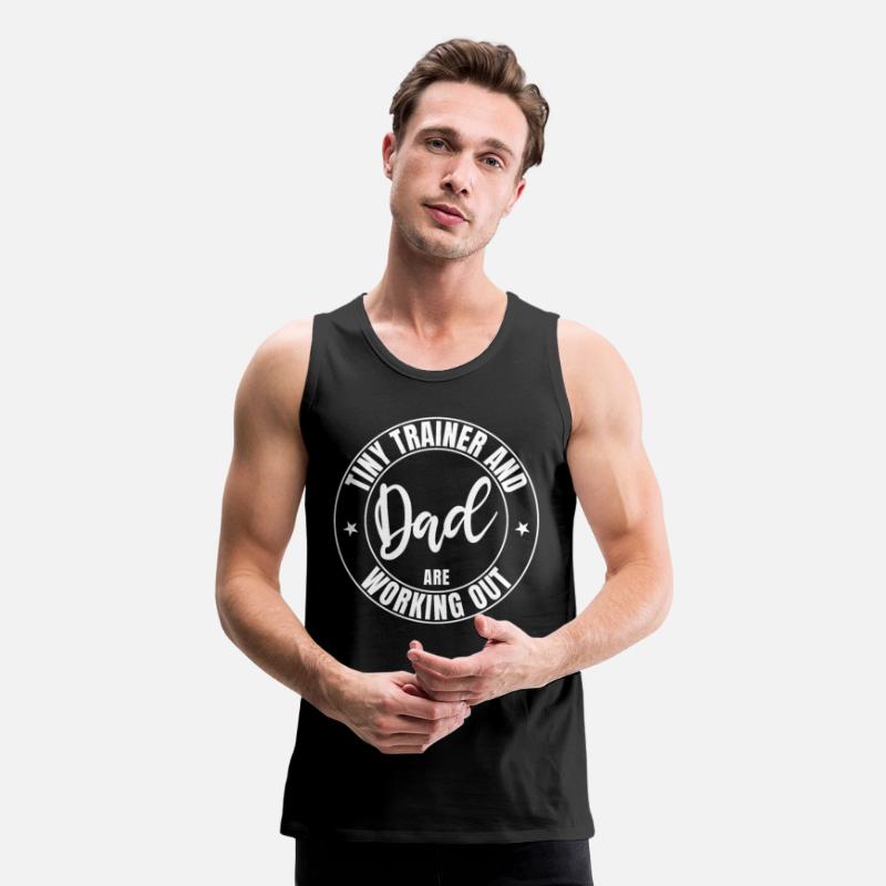 Dad and baby tiny trainer are working out in gym