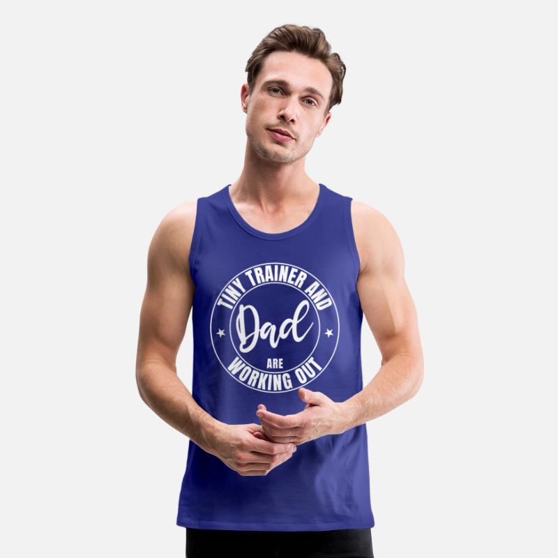 Dad and baby tiny trainer are working out in gym